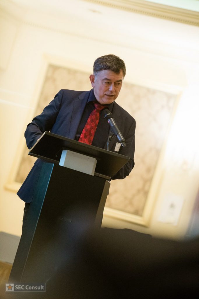 Person at the lectern - Global cybercrime - SEC Consult